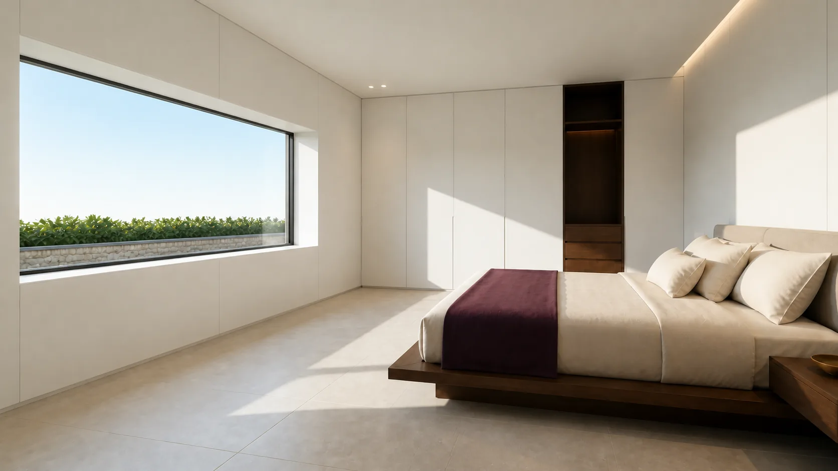 Sunlit bedroom with low timber bed, wide north window and fitted white storage