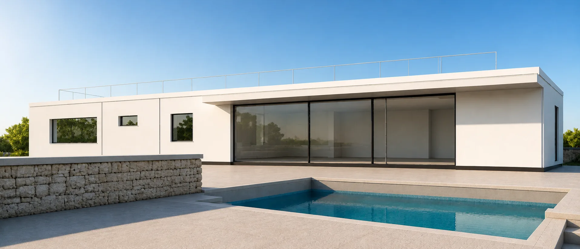Completed white villa facing its pool court behind the level-capped rubble rampart