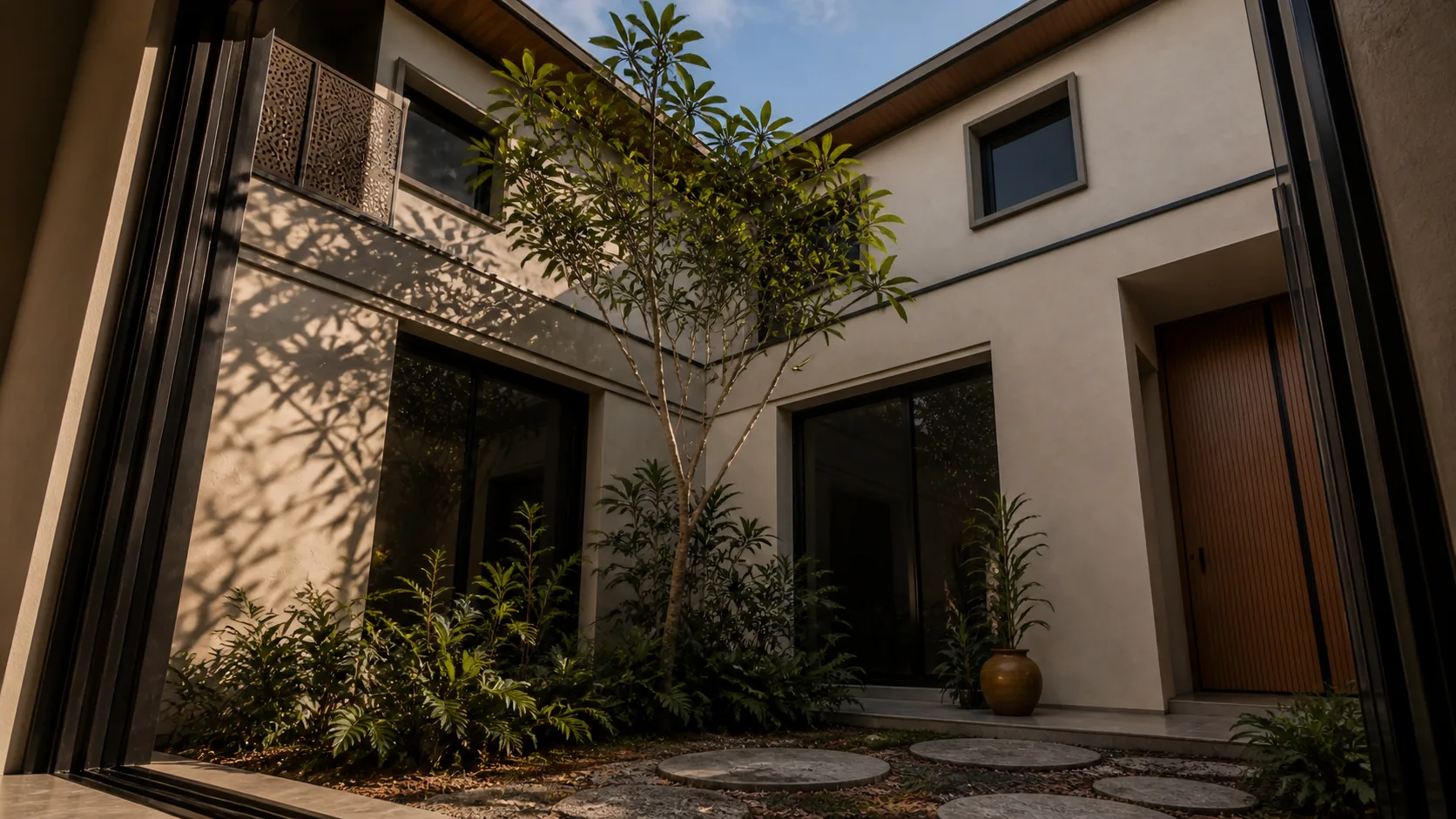 Frangipani rises in the court between pale walls and shaded bedroom windows